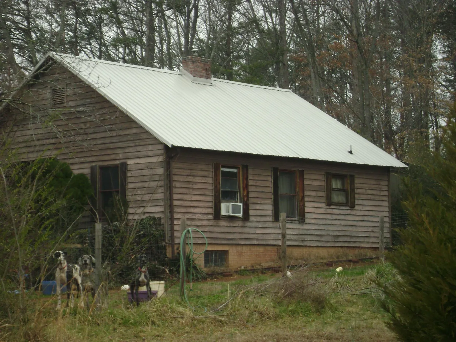 White metal roof on an old wood sided farmhouse, from a Metal Roof Installation job in Scandia
